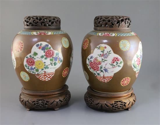 A pair of Chinese export Batavia ware famille rose jars, 18th century, H. 21cm, wood covers and stands